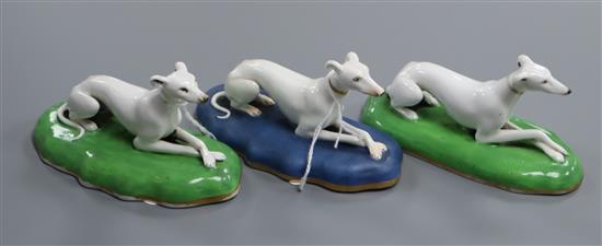 A pair of Staffordshire porcelain figures of recumbent greyhounds and another similar, c.1835-50, 12.2cm long (3)